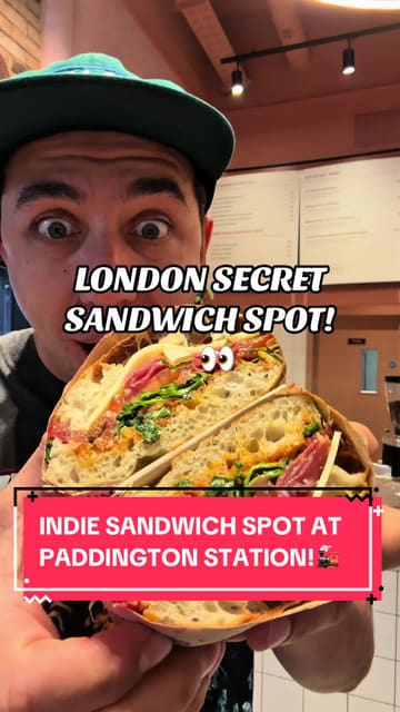 A high-energy, creator-led review of 'My Favourite Sandwich' at Paddington Station, showcasing their range of sandwiches, pastries, and coffee. The video features quick cuts, close-ups of food preparation, and the creator's enthusiastic reaction to the menu items.