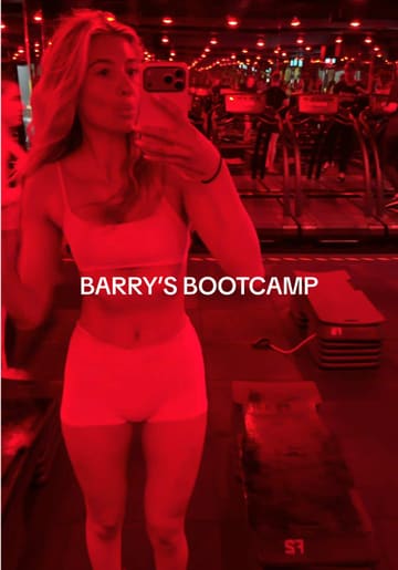 A candid vlog following a couple's experience at a Barry's Bootcamp class in London, highlighting the high-intensity workout, the red-lit studio environment, and the post-workout recovery shakes.