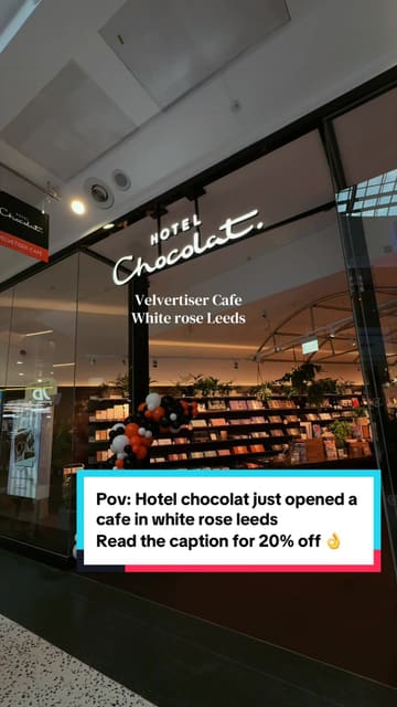 A short, aesthetic video tour of the newly opened Hotel Chocolat cafe at White Rose Leeds, featuring close-ups of ice cream preparation, the cafe interior, and an interactive chocolate quiz screen.