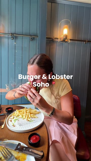 The video follows a creator's visit to Burger & Lobster in Soho, documenting the experience from arrival to the main course. It features a variety of dishes including oysters, a lobster martini, surf and turf carpaccio, calamari, steak, and a surf and turf burger, providing a clear overview of the menu offerings.