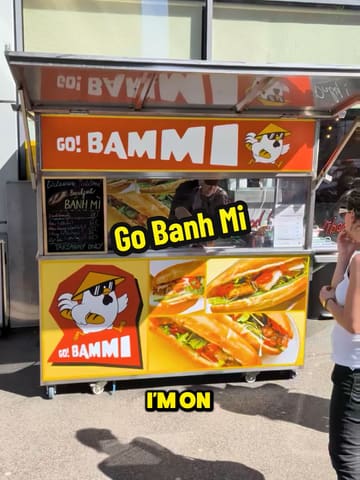 A creator visits a street food stall called 'Go Bammi' in Manchester to review their banh mi. The video follows the creator's journey to the stall, the ordering process, and a close-up look at the final sandwich.