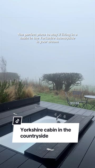 A short, atmospheric montage showcasing a cabin stay in the Yorkshire countryside, highlighting features like an outdoor bathtub, cozy interior with a fireplace, and scenic views.