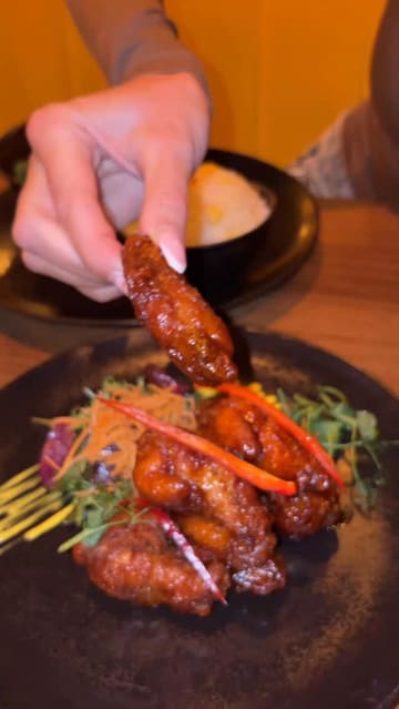 A promotional video featuring a creator visiting Siam Thai and Candlelight Bar in Dundrum, showcasing the interior, menu, food, and cocktails.