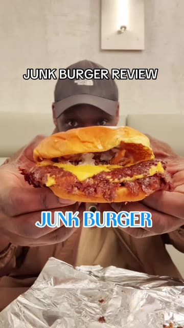 A first-person vlog review of a burger restaurant called Junk Burger. The creator walks through the experience of visiting the venue, ordering, and tasting the food, providing an honest critique of the quality.