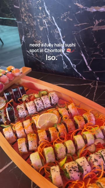 A short, fast-paced promotional video for Iso, a Japanese restaurant in Chorlton. The video features a quick tour of the interior, followed by a montage of various dishes including a sushi boat, bao buns, katsu curry, and mochi, emphasizing the venue's halal status.