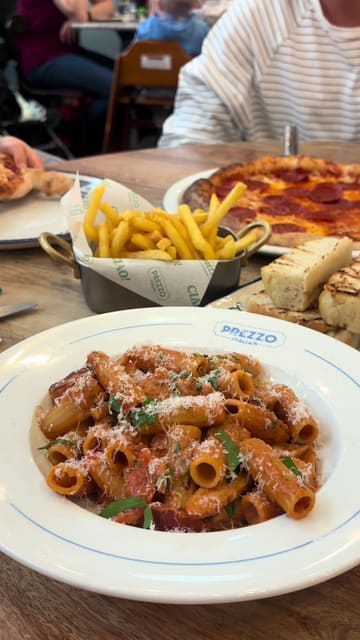 A family-focused vlog documenting a visit to a Prezzo restaurant, highlighting the kid-friendly menu, the 'kids eat free' offer, and the variety of Italian dishes enjoyed by the family.