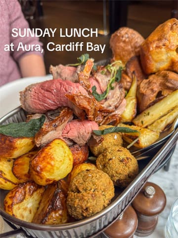 A short, engaging video showcasing a Sunday roast platter at Aura in Cardiff. The reel features close-ups of the food, a gravy pour, a cocktail, and shots of the restaurant interior, providing a good overview of the dining experience.