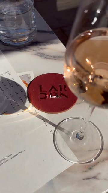 A promotional video showcasing Lardon restaurant in the Cotswolds, highlighting its outdoor terrace, interior dining space, menu offerings, and weekend DJ sets.