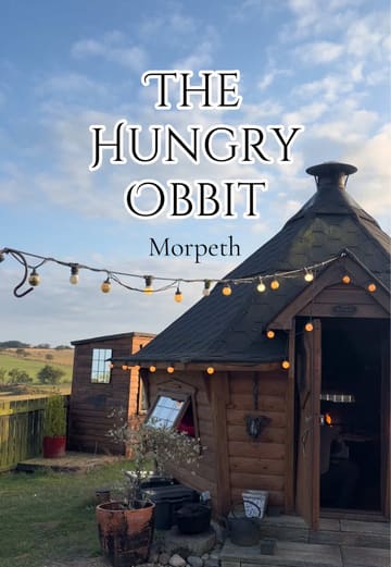 A montage showcasing a private dining experience at The Hungry Obbit in Morpeth, featuring a cozy wooden cabin setting with a central fire pit where food is cooked. The video highlights the rustic atmosphere, the interactive cooking process, the farm animals on-site, and the intimate group dining experience.