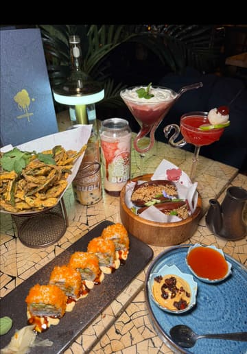 A creator visits Vermilion in Manchester, providing a tour of the three-story venue, including the cocktail bar and event space. The video highlights their new bubble tea range, various appetizers like prawn on toast bao and dragon maki, main courses such as lobster ravioli and drunken noodles, and a selection of desserts.