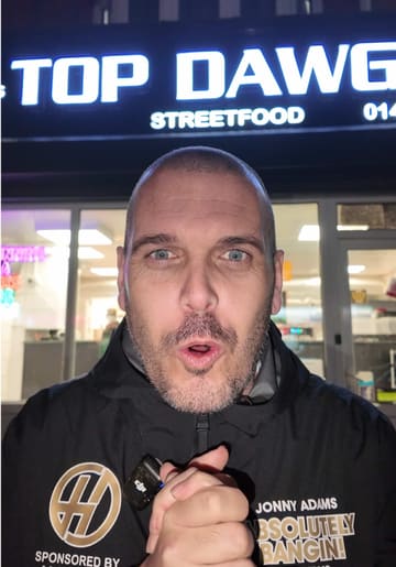 The creator reviews a 'munch box' from Top Dawgs in Hull, featuring a 10-inch pizza, two burgers, fries, and drinks. The video follows a vlog format, showing the exterior of the shop and the creator eating the food outside.