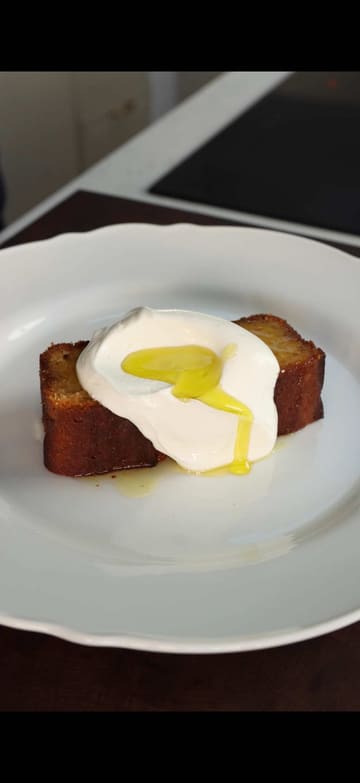A recipe video demonstrating how to make an olive oil, yuzu, and orange cake. The creator walks through the steps of zesting, mixing, and baking, resulting in a moist, citrusy dessert.