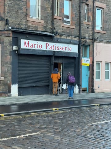 A creator visits a small, seemingly hidden Polish bakery in Edinburgh called Mario Patisserie. He documents his experience trying to visit, the shop's appearance, and performs a taste test of a doughnut and an apple pastry at home, providing a positive review of the quality and value.