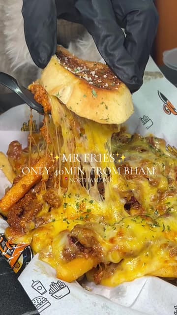 A fast-paced, visually driven promotional video for 'Mr Fries' in Northampton. The video features a series of close-up, high-quality shots of their signature loaded fries, burgers, and chicken tenders, emphasizing the indulgent nature of the food with cheese pulls and sauce dips. It includes brief shots of the restaurant's interior and menu board to provide context.