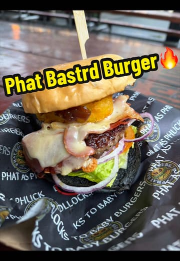 A vlog-style review featuring two creators trying burgers and loaded fries from Phat Bastrd Burger, located at the Botanic Inn in Belfast. The video highlights the quality of the food, including a Wagyu burger and salt and chilli chicken loaded fries, while also noting the venue's casual, outdoor setting.