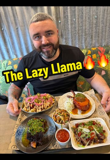 A couple reviews The Lazy Llama, a BBQ restaurant in Desertmartin. They showcase the venue's interior and outdoor seating, the menu, and several dishes including pork chops, loaded fries, brisket chili pie, and beef short rib.