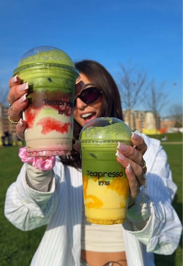 A creator visits Teapresso in Leeds to review their matcha drinks and ice cream. She showcases the strawberry matcha latte, mango coconut matcha latte, and a scoop of ice cream, providing her taste test and positive feedback.