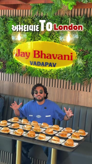 A high-energy, vlog-style review of Jay Bhavani Vadapav in London, highlighting their authentic Gujarati street food offerings including vada pav, maskabun, and Chinese bhel.