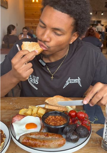 A video review of the Old Parlour Cafe at Spring Lane Farm Shop, featuring a full English breakfast, pancakes, and carrot cake.