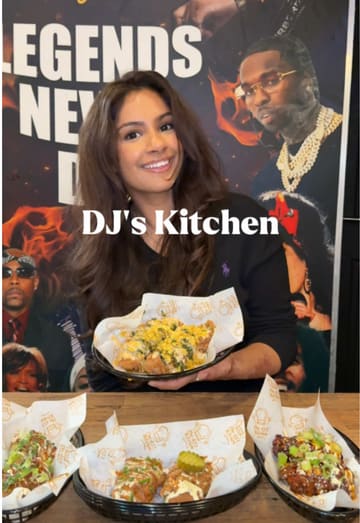 A review video featuring two creators tasting various chicken wing and tender flavors, a burger, and desserts at DJ's Kitchen. The video focuses on the flavor profiles and texture of the food.
