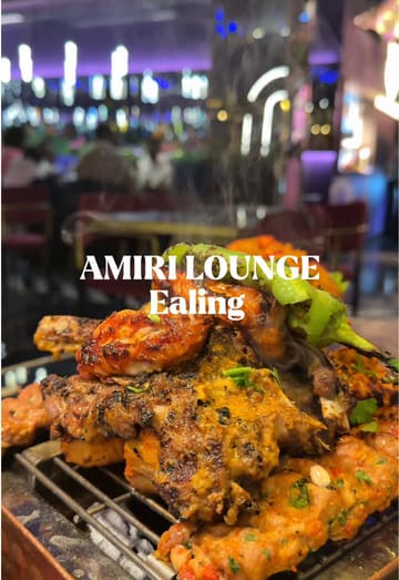 A couple visits Amiri Lounge in Ealing, showcasing a variety of dishes including a sizzling mixed grill, shrimp, biryani, and a milk cake dessert. The video features the creators trying the food and commenting on the flavors, highlighting the restaurant's Pan-Asian and Indian menu offerings.