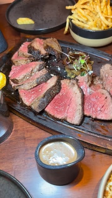 A short, punchy review of Bovinity steakhouse in Dublin, showcasing various dishes including steak, burrata, mac and cheese, and cheesecake, along with cocktails.