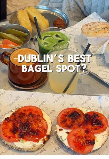 A review of a new bagel spot in Dublin called Volume[s], showcasing their menu, interior, and specific bagel orders including bacon, scallion cream cheese, and tomato.