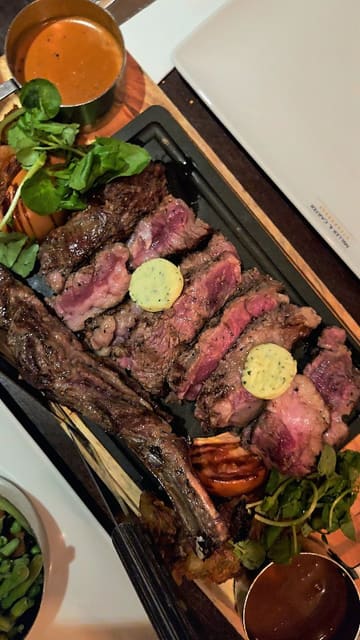 A short video review of a date night dinner at Miller & Carter, featuring close-up shots of the sourdough bread, pork belly starter, and a Côte de Boeuf sharing steak.