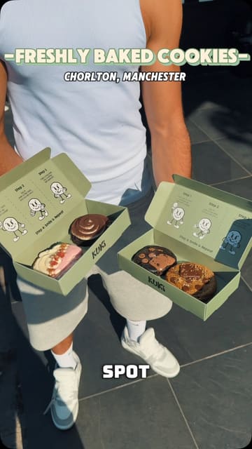A creator visits Kuki in Chorlton, Manchester, to review their freshly baked cookies. The video features a tour of the shop, a look at the display case, and the creator tasting a few different cookie varieties.