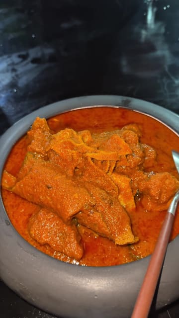 A creator visits NOK by Alara in Lagos, Nigeria, to try Abula for the first time. The video features the creator's honest review of the food and cocktails, along with shots of the restaurant's interior and exterior.