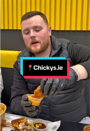 A casual, handheld vlog-style review of a chicken restaurant called Chickys. The creator samples various dishes including a rice box, burger, and chicken wings, providing commentary on the flavours and sauces.