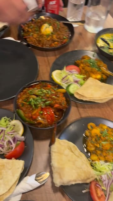 A group of friends visits Mishti Desh to celebrate, featuring a variety of Indian and Bengali dishes like biryani and murgi masala. The video is a casual, vlog-style review focusing on the social experience and the food.