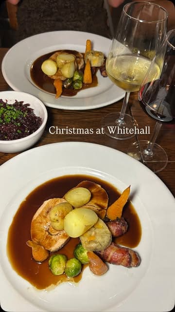 A montage video showcasing a group dinner at The Whitehall in Leeds, featuring shots of the Christmas menu, various courses including roast dinner and dessert, cocktails, and the lively atmosphere of the group dining experience.