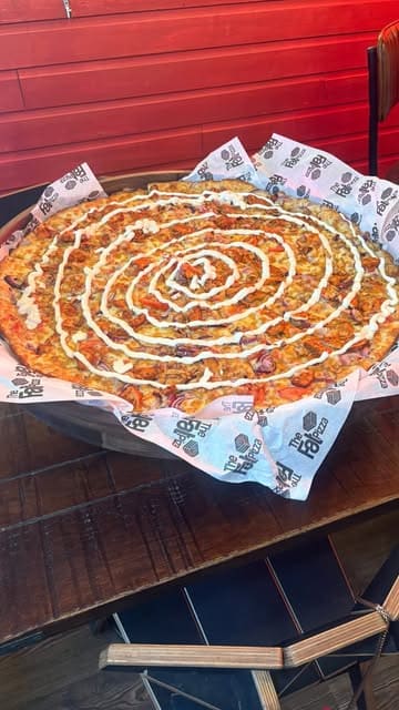 A promotional video for The Fat Pizza, showcasing their large pizzas, cocktails, and competitive socialising games like darts and shuffleboard. The video uses a voiceover to guide the viewer through the menu variety and the venue's suitability for groups and families.