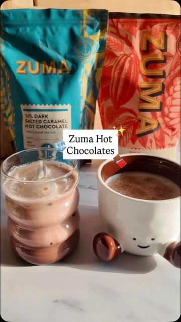 A creator demonstrates how to prepare hot and iced chocolate drinks using Zuma hot chocolate powders in a home kitchen setting.