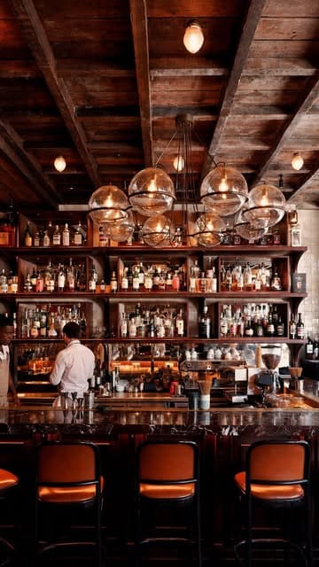 A montage of high-quality shots featuring the interior of Wild restaurant, including close-ups of wine, grilled prawns, steak, and tiramisu, set to music.
