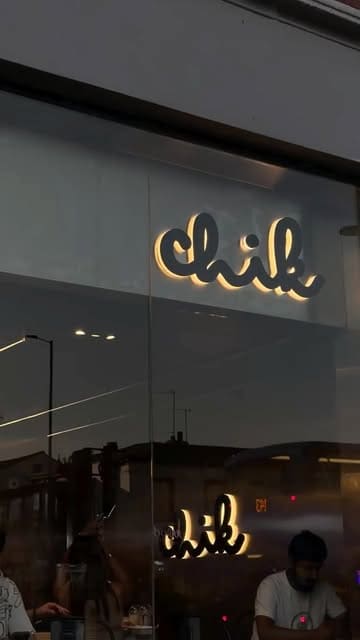 A promotional reel for the opening of a new restaurant called Chik, featuring the venue's interior, branding, and a variety of food items including burgers, fries, rice bowls, and cookies.