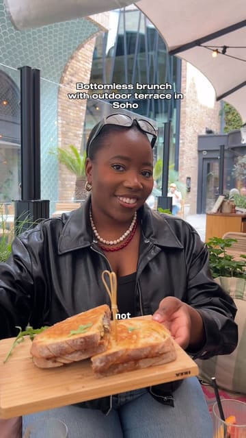 A vlog-style review of a bottomless brunch at The Little Scarlet Door in Soho, featuring a variety of cocktails, charcuterie boards, and toasties. The creator highlights the menu, the atmosphere, and the value for money.
