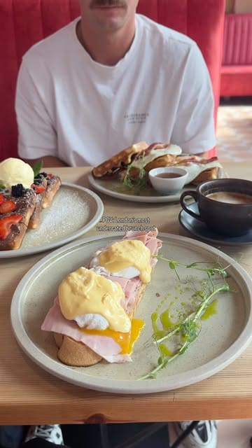 A short montage showcasing the brunch menu and interior of Mirella in Leytonstone, featuring dishes like eggs benedict, waffles, and coffee, while highlighting the dog-friendly atmosphere.