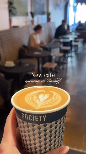 A vlog-style reel showcasing the opening of a new Society Cafe location in Cardiff, highlighting the interior, coffee, pastries, and merchandise.