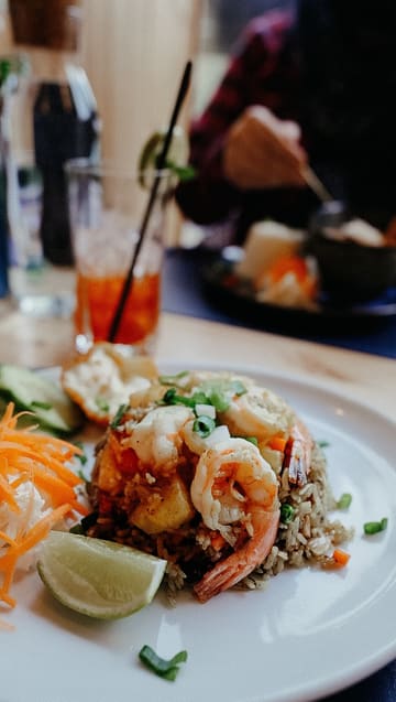 A review of The Thai Bar and Restaurant in Glasgow, featuring a variety of dishes including pandan leaf chicken, fish cakes, pineapple fried rice, beef massaman curry, and their signature cheesecake.