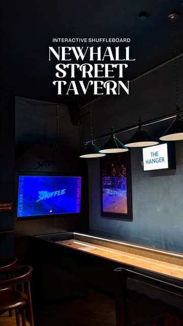 A promotional reel for Newhall Street Tavern in Birmingham, showcasing their interactive shuffleboard tables, cocktail menu, and food offerings like pizza and fried chicken.