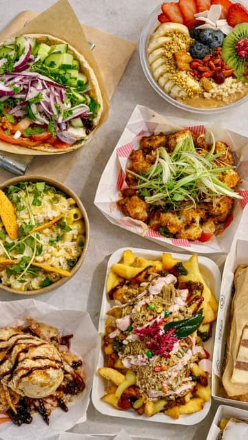 A fast-paced tour of Newport Market, highlighting various food and drink vendors, including Greek, Italian, Indian, and dessert options, showcasing the vibrant atmosphere and variety of the venue.