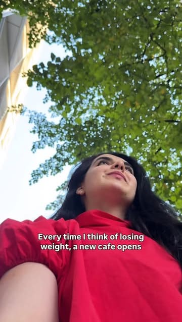 A creator visits a new cafe on Edgware Road, reviewing their frappes, sandwiches, and desserts, specifically highlighting the Kinder Bueno and Snickers cheesecake.