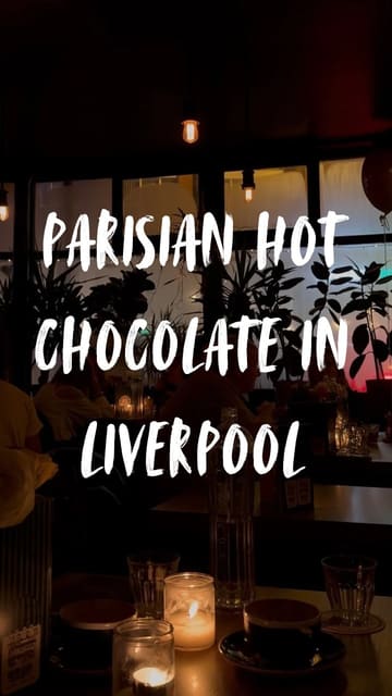 A short, atmospheric video showcasing a rich hot chocolate served with cream at Petit Cafe du Coin. The lighting is very dim, creating a cozy, intimate vibe, though the video is static and lacks a clear narrative or tour of the venue.