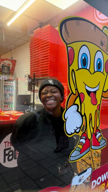 A creator visits The Fat Pizza, showcasing the takeaway venue, the ordering process, and a variety of food items including a 24-inch pizza, burgers, chicken wings, curly fries, and desserts, while mentioning watching football.