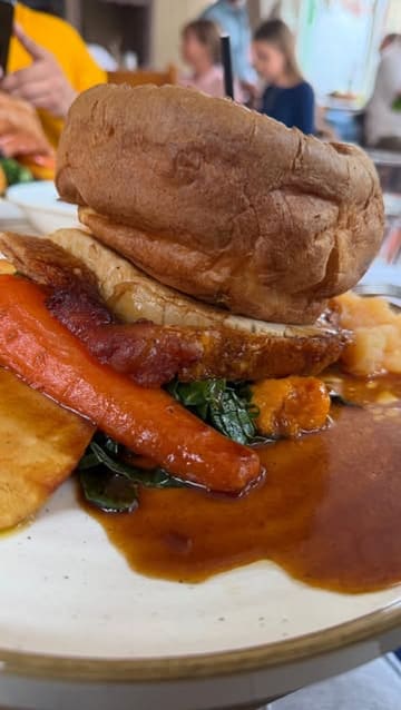 A short, engaging vlog-style video featuring a creator and their friend enjoying a Sunday Roast and cocktails at The Garrison. The video highlights the food, including a starter and the main roast, while capturing the social atmosphere of the meal.