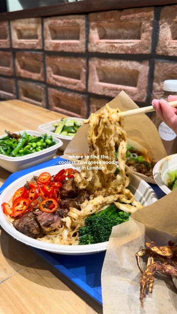 A fast-paced, engaging reel showcasing Kung Fu Mama, a Taiwanese noodle bar in London. The video features a variety of shots including the exterior, self-service ordering kiosks, kitchen preparation, and close-ups of various dishes like beef noodles, soft shell crab bao, and mango shaved ice.
