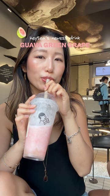 A couple visits a Heytea location to try their new Guava Green Grape drink, showcasing the preparation process and their reactions.