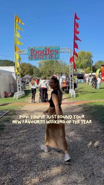 A fast-paced vlog-style reel showcasing a visit to the Foodies Festival. The video features a variety of food and drink options, including noodles, pizza, mac and cheese, and cocktails, alongside scenes of the creator and her family enjoying the atmosphere, music, and activities.